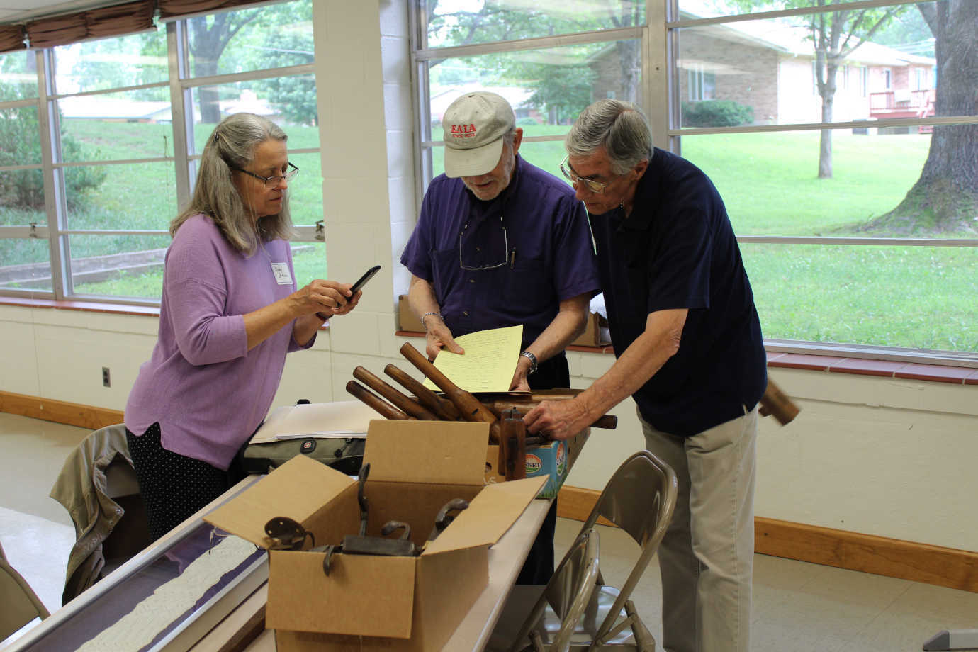 Cindy Browne of Deutschheim State Historic Site learns about Laurent Torno&rsquo;s German shoemaking tools from the 1840s. Photo courtesy of Missouri Humanities.