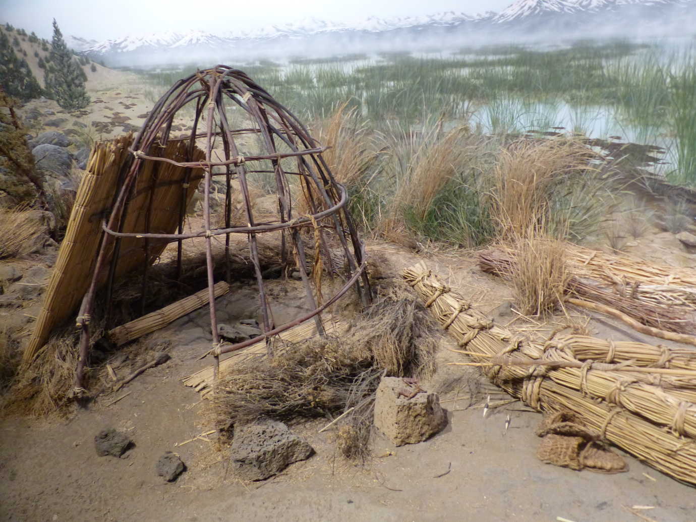 The High Desert Museum&rsquo;s *Spirit of the West* exhibition begins with a Northern Paiute scene from Nevada&mdash;carefully embedded in the scene is the use of tule (a native reed) in the scene&rsquo;s wickiup, cultural objects, and tule reed watercraft. Image courtesy of the High Desert Museum.