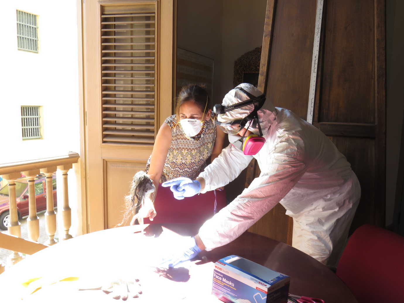 National Heritage Responder Molly O&rsquo;Guinness Carlson instructs a staff member on how to effectively dry an object in the sunlight at a Puerto Rican museum. Image courtesy of FAIC.
