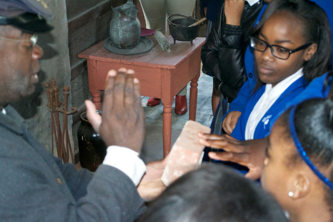 Participants examine historic artifacts in former slave quarters as part of their tour &ldquo;Behind the Big House,&rdquo; funded through the Racial Equity Grants program. Photo courtesy of Mississippi Humanities Council.